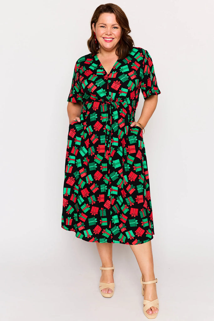 Pocket view – Michelle dress in Christmas Presents print, red and green presents pattern