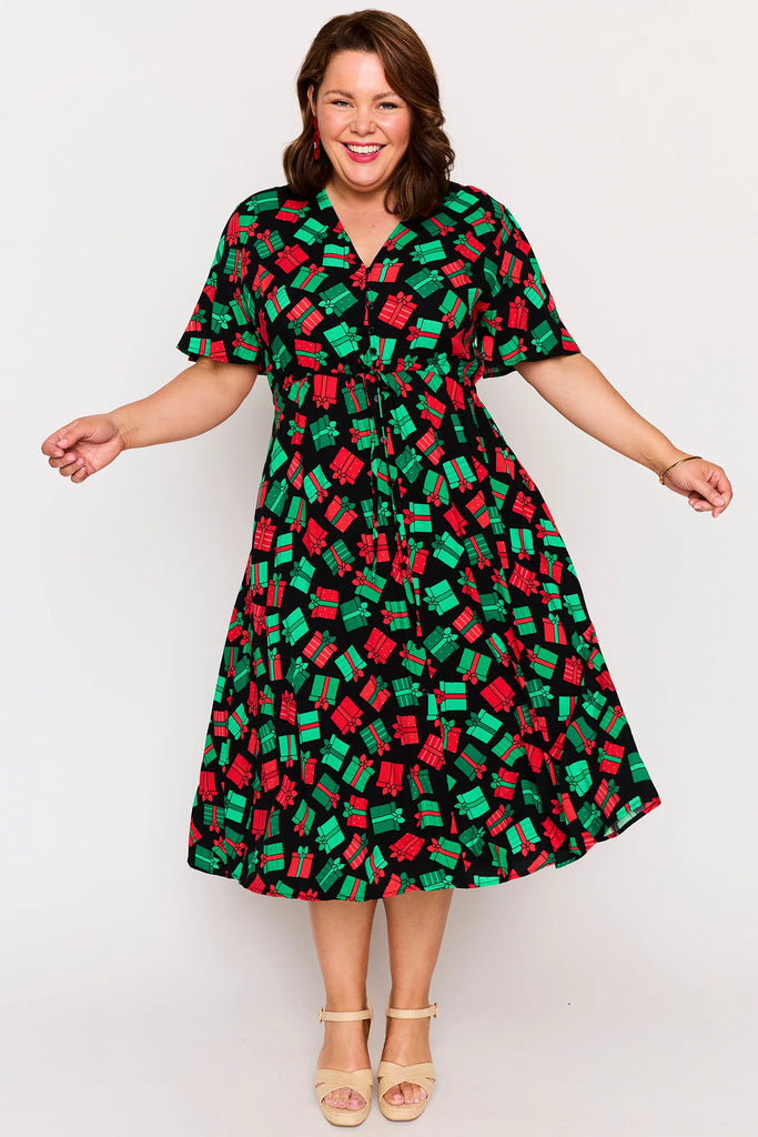 Front view – Michelle dress in Christmas Presents print, red and green presents pattern