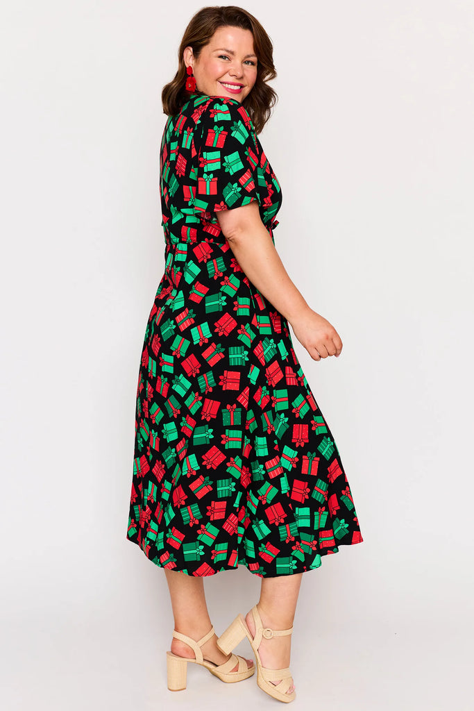 Side view - Full Body – Michelle dress in Christmas Presents print, red and green presents pattern