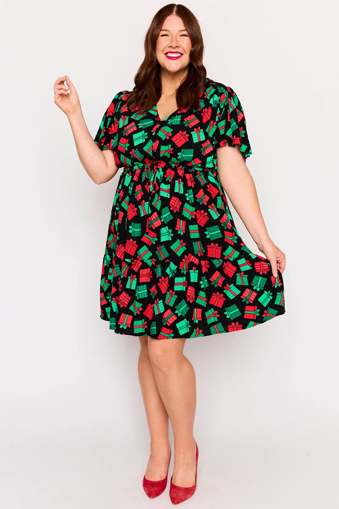 Front View - Full skirt view – Remi dress in Christmas Presents print, white base with red and green gifts