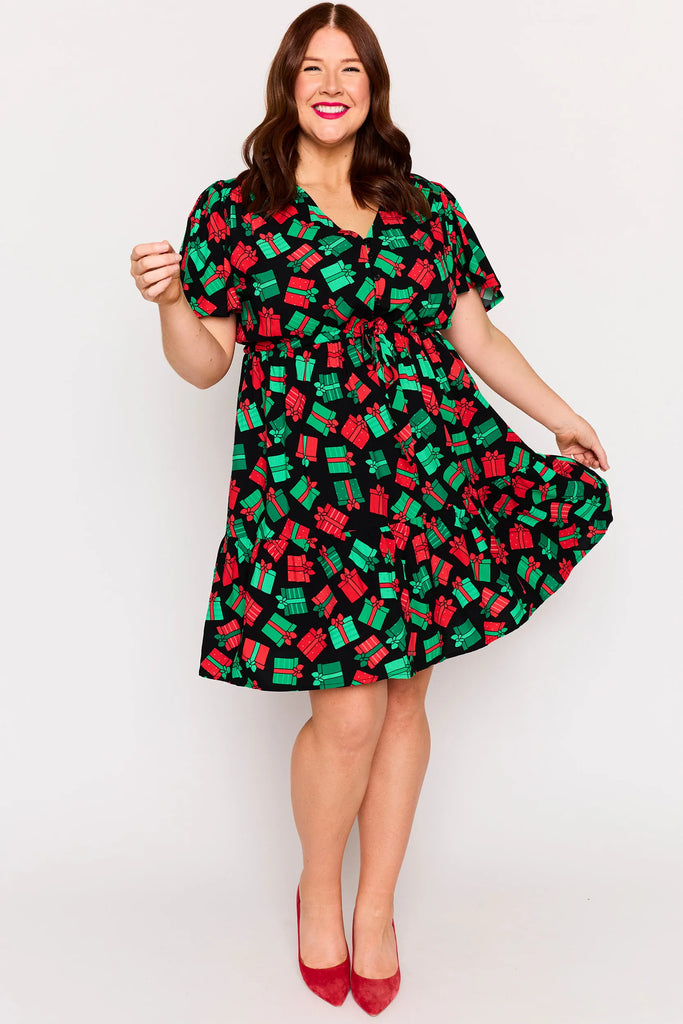 Front view – Remi dress in Christmas Presents print, white base with red and green gifts