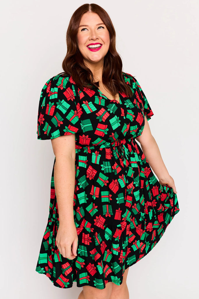 Close-Up - Skirt detail – Remi dress in Christmas Presents print, white base with red and green gifts