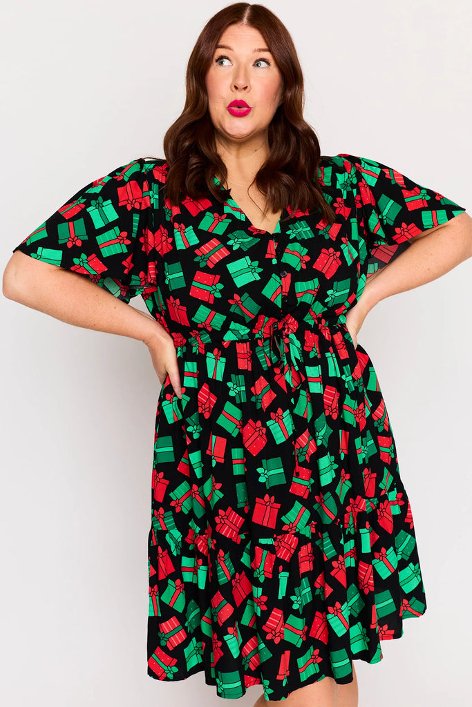 Close-Up - Sleeve detail – Remi dress in Christmas Presents print, white base with red and green gifts